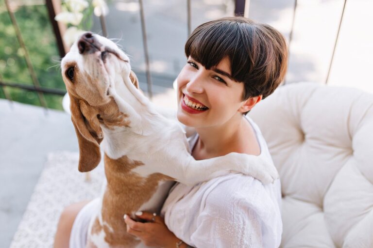 Owner hugging dog